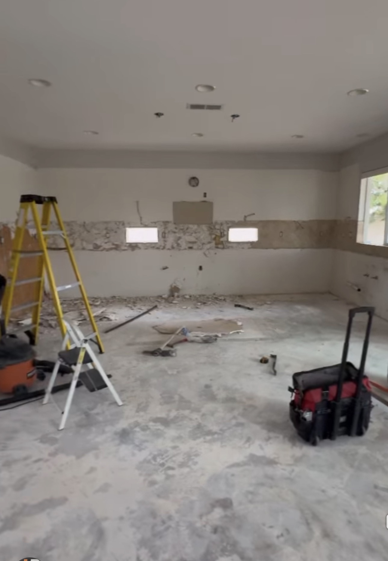 Kitchen stripped to wall framing during full demolition