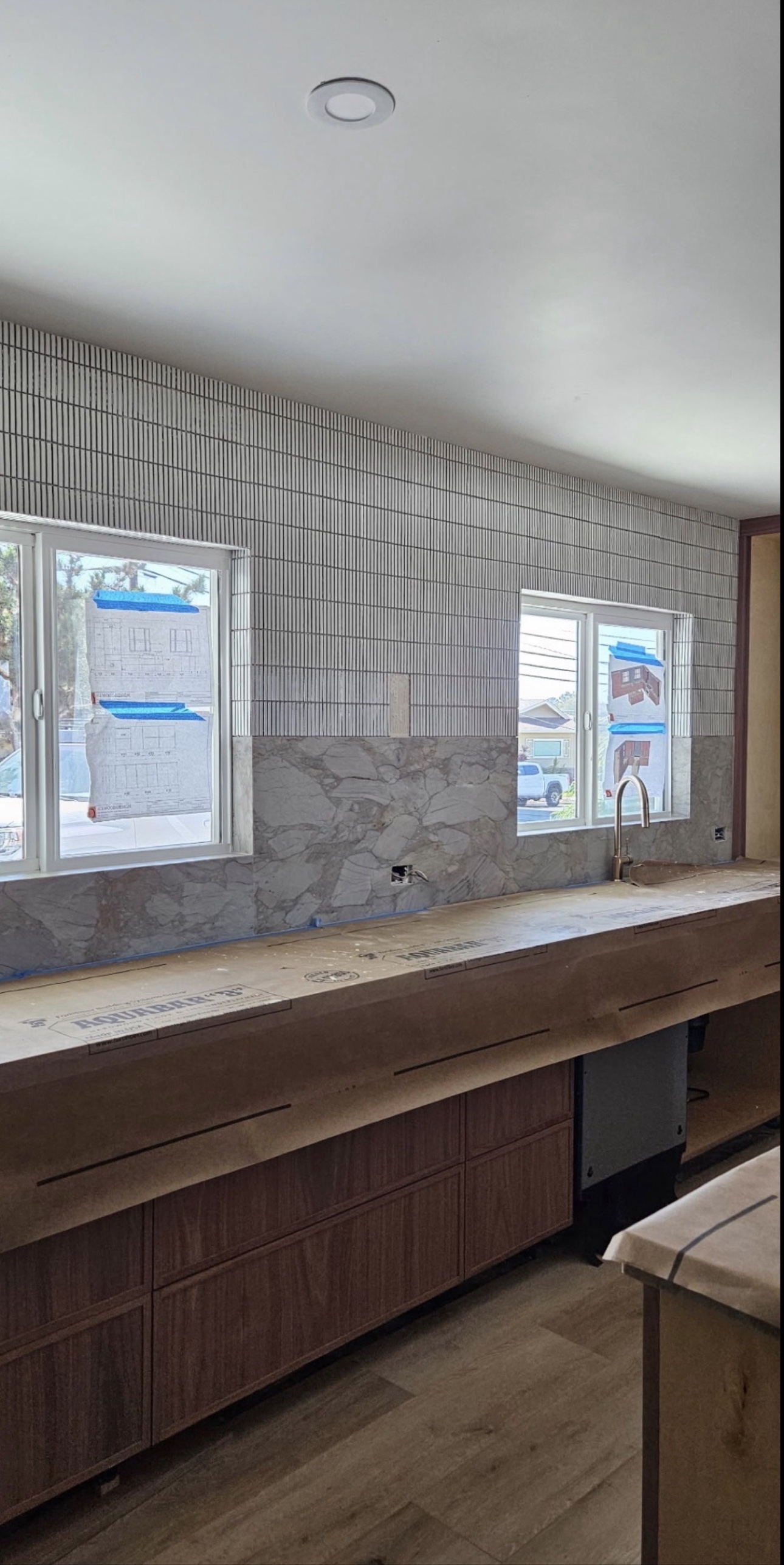 Kit-kat tile and marble slab backsplash with the faucet set