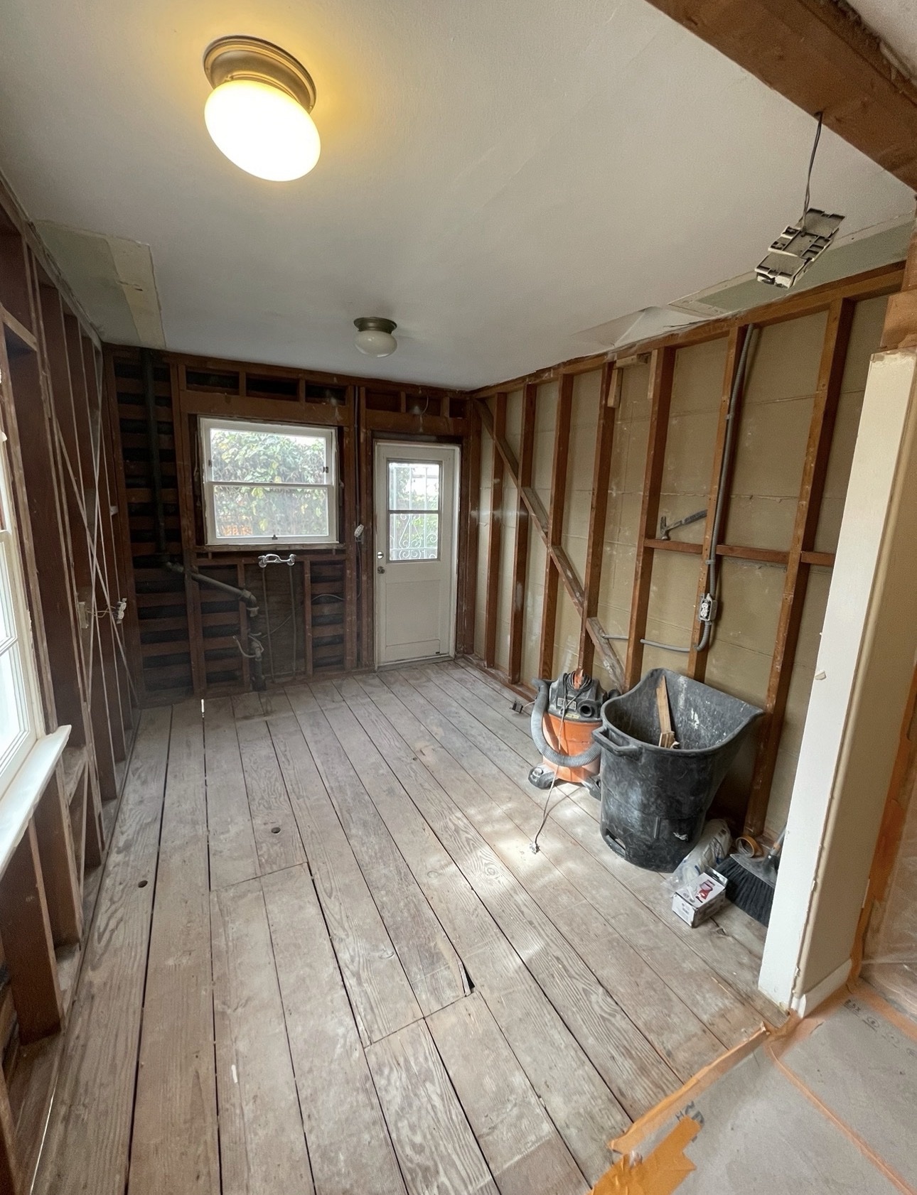 Adams North Park kitchen remodel during demolition with the walls stripped to their wood framing