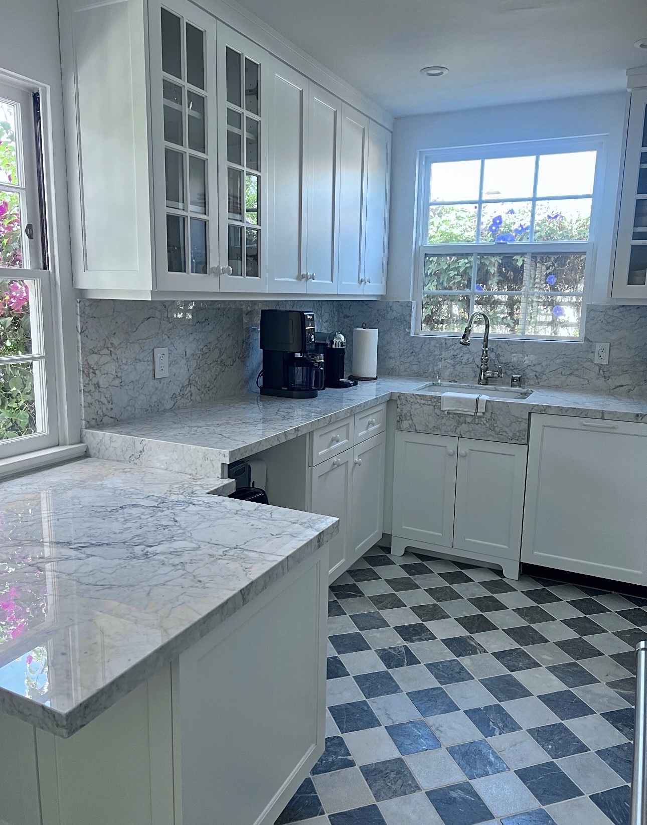 Corner view of the finished Adams North Park kitchen with marble peninsula, coffee station and window over the farmhouse sink